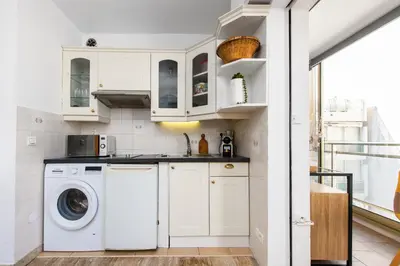 a white kitchen with a washer and dryer at Hypercentre - Plage - Croisette - Palais - CJ in Cannes