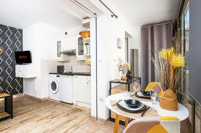 a kitchen and living room with a table and chairs at Hypercentre - Plage - Croisette - Palais - CJ in Cannes