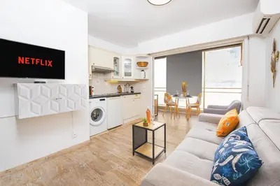 a living room with a couch and a kitchen at Hypercentre - Plage - Croisette - Palais - CJ in Cannes