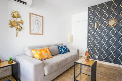 a living room with a couch and a table at Hypercentre - Plage - Croisette - Palais - CJ in Cannes