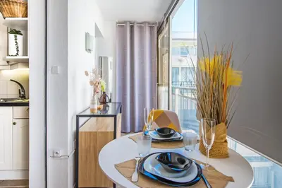 a dining room with a white table and a window at Hypercentre - Plage - Croisette - Palais - CJ in Cannes