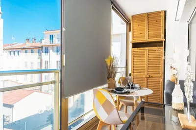 a dining room with a table and a large window at Hypercentre - Plage - Croisette - Palais - CJ in Cannes