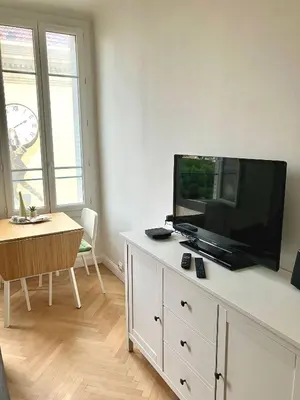 a living room with a flat screen tv on a dresser at Cannes Centre Apartment 2-Room by Palais des Festivals & Beach in Cannes