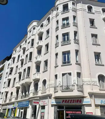 a large white building with balconies on a street at Cannes Centre Apartment 2-Room by Palais des Festivals & Beach in Cannes