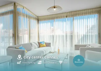 a living room with a couch and a table at Hypercentre - Palais - Croisette - Plage - CI in Cannes