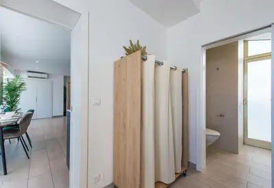 a bathroom with wooden dividers with a toilet and a table at Hypercentre - Palais - Croisette - Plage - CI in Cannes
