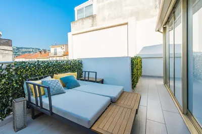 a balcony with a couch on a patio at Hypercentre - Palais - Croisette - Plage - CI in Cannes