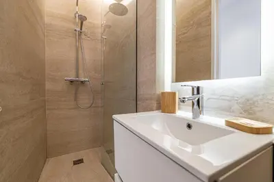 a bathroom with a white sink and a shower at 49 CLEM - Superbe appartement 2 chambres 4 pers avec vue mer in Cannes