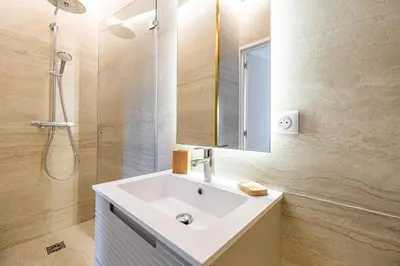 a bathroom with a sink and a shower and a mirror at 49 CLEM - Superbe appartement 2 chambres 4 pers avec vue mer in Cannes
