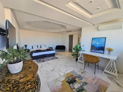 a living room with a bed and a table at Rare Penthouse - Vue panoramique in Cannes