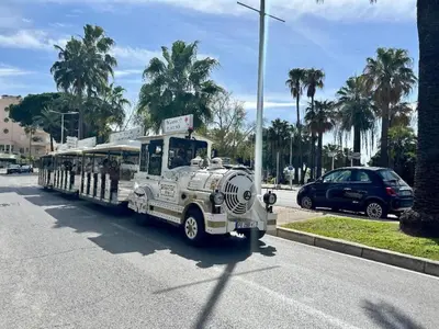 an old bus is driving down a street at Seabatical Apartment by the beach, 2Bed and 2Baths in Cannes