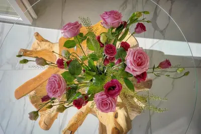 a bouquet of pink roses in a vase on a table at Seabatical Apartment by the beach, 2Bed and 2Baths in Cannes
