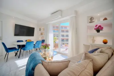 a living room with a couch and a dining room at Seabatical Apartment by the beach, 2Bed and 2Baths in Cannes