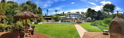 a house with a yard with a pool and a house at Villa Caribbean in Cannes