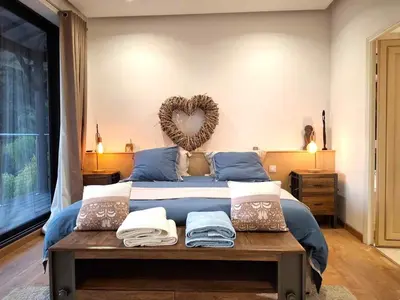 a bedroom with a bed with a heart on the wall at Villa Caribbean in Cannes