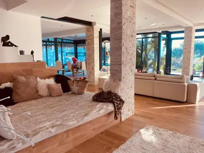 a bedroom with a large bed and a living room at Villa Caribbean in Cannes