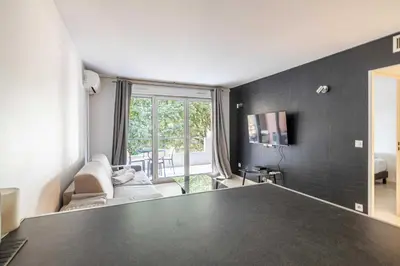 a living room with a large black counter top at Magnificent apartment with parking - AC-balcony in Cannes