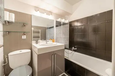 a bathroom with a toilet and a sink and a tub at Magnificent apartment with parking - AC-balcony in Cannes
