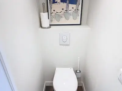 a bathroom with a toilet with a picture on the wall at Superbe appartement terrasse vue mer 347L GLEN in Cannes