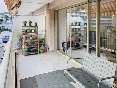 a balcony with a bench on a balcony at Superbe appartement terrasse vue mer 347L GLEN in Cannes