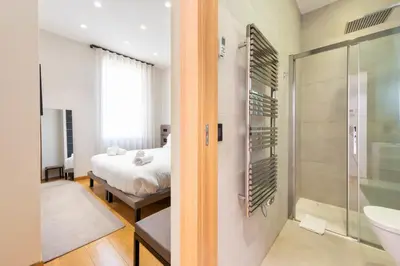 a bathroom with a shower and a bedroom with a bed at DUPLEX 145m Private Terrace and Elevator in Cannes