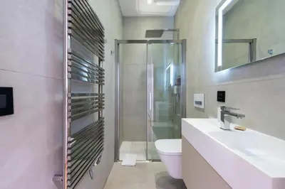 a bathroom with a shower and a sink and a toilet at DUPLEX 145m Private Terrace and Elevator in Cannes