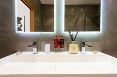 a bathroom with two sinks and a mirror at DUPLEX 145m Private Terrace and Elevator in Cannes