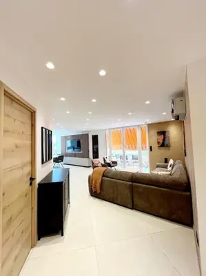 a living room with a large couch in a room at Appartement 4 pièces luxueux in Cannes