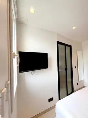 a bedroom with a flat screen tv on the wall at Appartement 4 pièces luxueux in Cannes