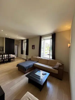 a living room with a couch and a table at dans le quartier historique du suquet idéal congres et vacances in Cannes