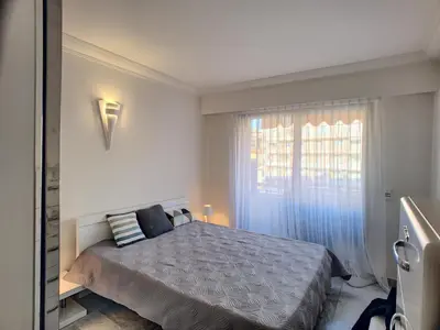 a bedroom with a large bed and a window at Superbe vue mer terrasse - 218L MISS in Cannes