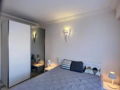 a bedroom with a bed with two lamps on it at Superbe vue mer terrasse - 218L MISS in Cannes