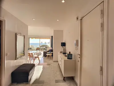 a living room with a bed and a table with a view at Superbe vue mer terrasse - 218L MISS in Cannes