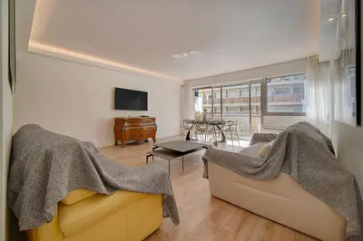 a living room with a couch and a tv at REF 1425 - Cannes Center - Apartment for rent in Cannes