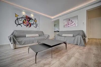a living room with two beds and a table at REF 1425 - Cannes Center - Apartment for rent in Cannes