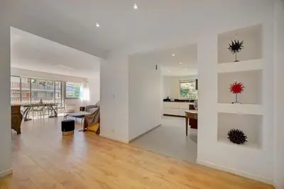 a living room with white walls and a dining room at REF 1425 - Cannes Center - Apartment for rent in Cannes
