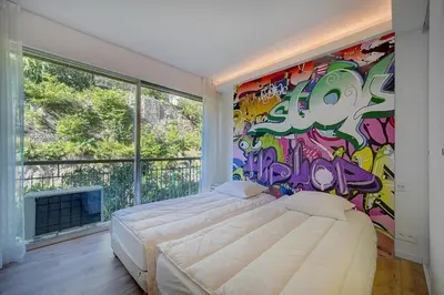 a bedroom with a painting on the wall at REF 1425 - Cannes Center - Apartment for rent in Cannes