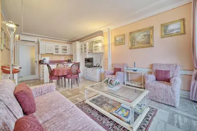 a living room with a couch and a table at REF 1908 - Cannes Croisette - Apartment for rent in Cannes
