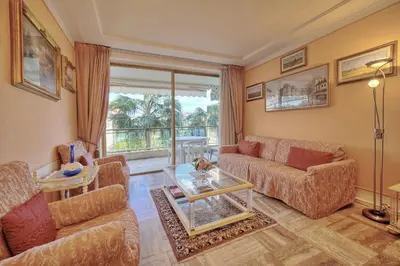 a living room with a couch and a table at REF 1908 - Cannes Croisette - Apartment for rent in Cannes