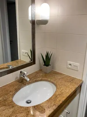 a bathroom counter with a sink and a mirror at Centre-ville de Cannes 100 m mer in Cannes