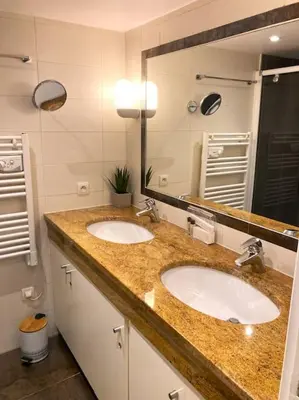 a bathroom with two sinks and a large mirror at Centre-ville de Cannes 100 m mer in Cannes