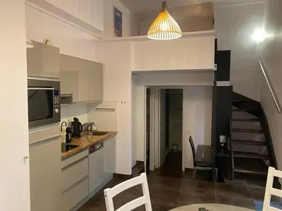 a kitchen with a sink and a staircase in a room at Centre-ville de Cannes 100 m mer in Cannes