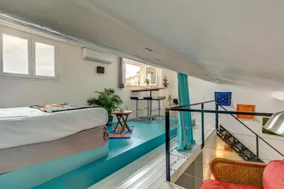 a small room with a bed and a balcony at Cocoon'in Cannes Le Suquet in Cannes