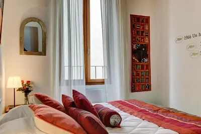 a bedroom with a bed with red pillows on it at Cocoon'in Cannes Le Suquet in Cannes