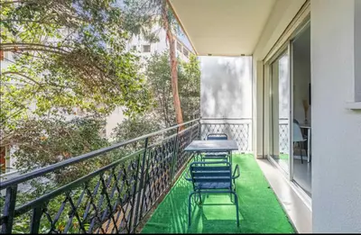 a balcony with two chairs and a table on it at Appartement disign CLUB B in Cannes