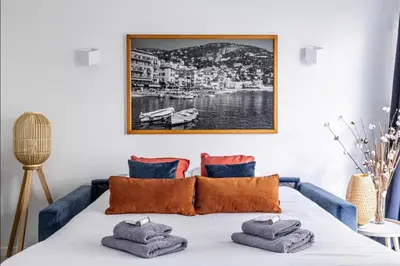 a room with a bed with towels on it at Appartement disign CLUB B in Cannes