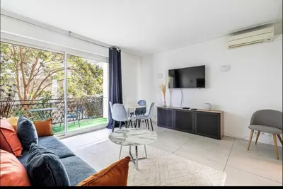 a living room with a couch and a table at Appartement disign CLUB B in Cannes
