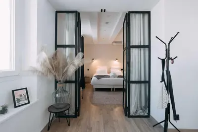 a room with a bedroom with a bed and a mirror at Bulle d'Amour - Jacuzzi, 10mn Palais&Plage, Centre in Cannes