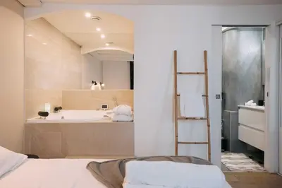 a bathroom with a tub and a sink at Bulle d'Amour - Jacuzzi, 10mn Palais&Plage, Centre in Cannes
