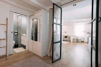 a room with a glass door leading to a living room at Bulle d'Amour - Jacuzzi, 10mn Palais&Plage, Centre in Cannes